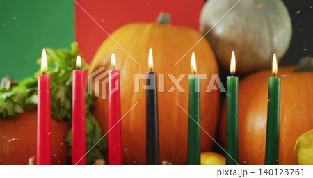 Displaying seven lit taper candles forming straight row on tabletop, with pumpkins, gourd, foliage Displaying seven lit taper candles forming straight row on tabletop, with pumpkins, gourd, foliage 140123761
