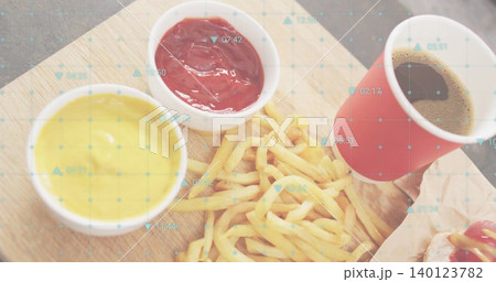 Framing golden fries pile on board at fast-food table, ketchup, red cup, wrapper, blue grid overlay Framing golden fries pile on board at fast-food table, ketchup, red cup, wrapper, blue grid overlay 140123782