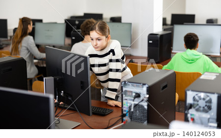 Young girl learning to use personal computer during lesson Young girl learning to use personal computer during lesson 140124053