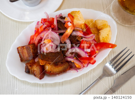 Braised chicharron with fried yuca and salad Braised chicharron with fried yuca and salad 140124150