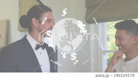 Talking men in tuxedo and white T-shirt discussing finance at home, with currency globe overlay 140124178