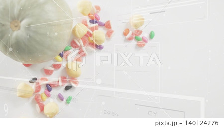 Displaying pale green gourd on white tabletop trailing jellybeans gumdrops and overlays, copy space Displaying pale green gourd on white tabletop trailing jellybeans gumdrops and overlays, copy space 140124276