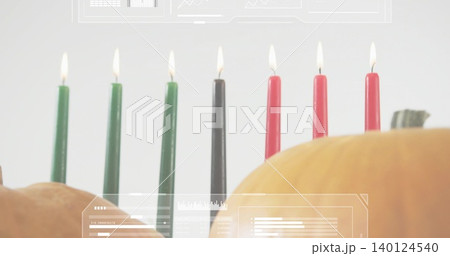 Showing seven lit taper candles green-black-red on table with two pumpkins and faint HUD overlays 140124540