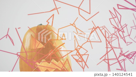 Glowing carved pumpkin emitting warm light at studio with green stem, wireframe shapes, copy space Glowing carved pumpkin emitting warm light at studio with green stem, wireframe shapes, copy space 140124541