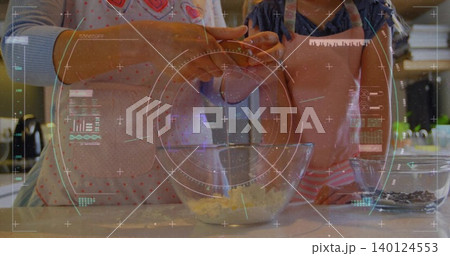 Mother and daughter cracking egg over glass mixing bowl at kitchen counter, with chips, aprons, HUD Mother and daughter cracking egg over glass mixing bowl at kitchen counter, with chips, aprons, HUD 140124553