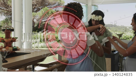 Embracing two women wearing green dress and blue dress on veranda, cupcake stand and AR 3549 140124835