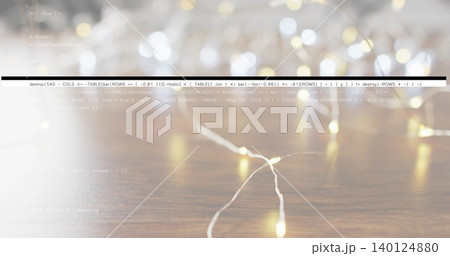 Glowing warm white LED strand resting on wooden tabletop, showing wire, dark bar and code overlay Glowing warm white LED strand resting on wooden tabletop, showing wire, dark bar and code overlay 140124880
