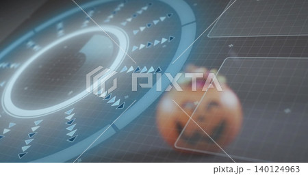 Showing circular HUD glowing with rings and spinning arrows in virtual grid with carved pumpkin Showing circular HUD glowing with rings and spinning arrows in virtual grid with carved pumpkin 140124963