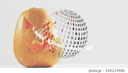 Displaying carved jack o lantern on table, floating binary sphere with glowing ribbon, copy space Displaying carved jack o lantern on table, floating binary sphere with glowing ribbon, copy space 140124986