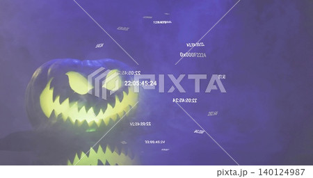 Glowing jack-o'-lantern pumpkin casting reflection on table in studio with purple fog and codes Glowing jack-o'-lantern pumpkin casting reflection on table in studio with purple fog and codes 140124987