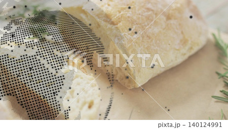 Showing wedge of aged cheese crumbling on parchment on wood with rosemary, crumbs, halftone Showing wedge of aged cheese crumbling on parchment on wood with rosemary, crumbs, halftone 140124991