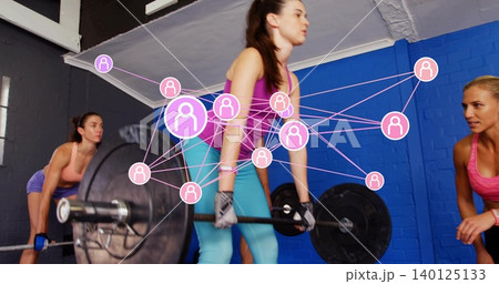 Deadlifting woman in purple tank, teal tights holding loaded bar with gloves, pink network at gym Deadlifting woman in purple tank, teal tights holding loaded bar with gloves, pink network at gym 140125133