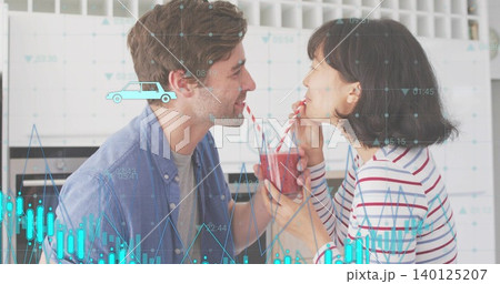 Sharing couple sipping smoothie from jar in kitchen, striped top, striped straws, data overlay Sharing couple sipping smoothie from jar in kitchen, striped top, striped straws, data overlay 140125207