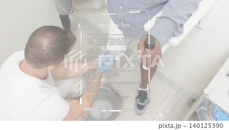 Kneeling clinician tending lower leg at clinic, with forearm crutch brace HUD COLLECTING DATA 140125390