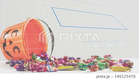 Tipping orange pumpkin bucket spilling wrapped candy on white table, with 3D grid and blue polygons 140125478
