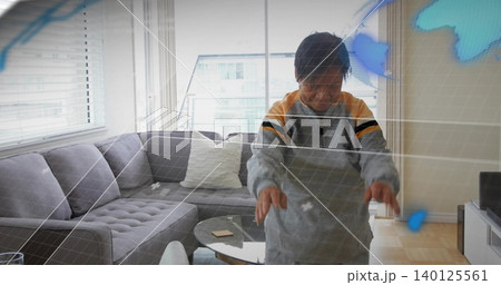 Reaching senior Chinese woman touching blue hologram in living room with grey sofa, coffee table Reaching senior Chinese woman touching blue hologram in living room with grey sofa, coffee table 140125561