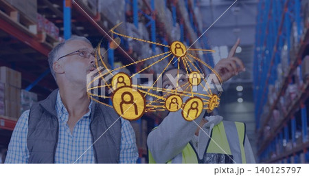 Pointing woman in hi vis vest guiding male manager in quilted vest in warehouse, hologram network Pointing woman in hi vis vest guiding male manager in quilted vest in warehouse, hologram network 140125797