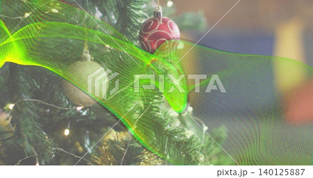 Displaying tree branch at home, with red bauble, warm lights, tinsel, neon wave, copy space Displaying tree branch at home, with red bauble, warm lights, tinsel, neon wave, copy space 140125887