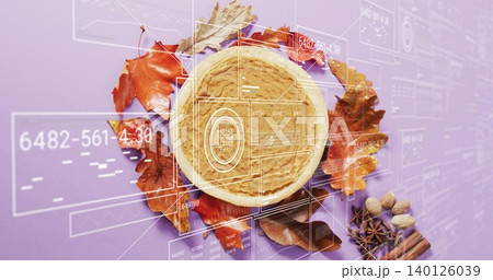 Showcasing round tart in tart pan on purple surface, with leaves, cinnamon, nuts, HUD Showcasing round tart in tart pan on purple surface, with leaves, cinnamon, nuts, HUD 140126039
