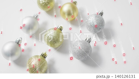 Metallic gold silver baubles resting on white table, showing 0s and 1s falling in red-white streams Metallic gold silver baubles resting on white table, showing 0s and 1s falling in red-white streams 140126131