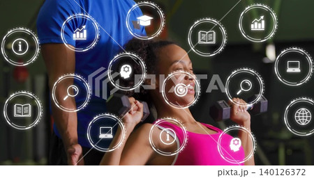 Pressing woman in pink top lifting dumbbells at gym bench, blue-shirt trainer spotting, HUD icons Pressing woman in pink top lifting dumbbells at gym bench, blue-shirt trainer spotting, HUD icons 140126372