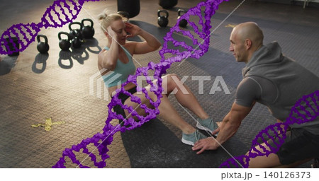 Doing woman in bra performing situps at gym coach holding feet kettlebells DNA overlay, copy space 140126373