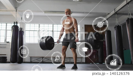 Lifting shirtless man in dark shorts black shoes performing deadlift at gym with barbell, HUD Lifting shirtless man in dark shorts black shoes performing deadlift at gym with barbell, HUD 140126376