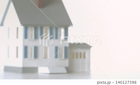 Scale model house is sitting in minimalist shot with blue shutters for real estate, copy space Scale model house is sitting in minimalist shot with blue shutters for real estate, copy space 140127398