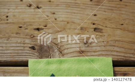 Green felt with printed shapes is lying on wood planks in flat design showing education theme Green felt with printed shapes is lying on wood planks in flat design showing education theme 140127478