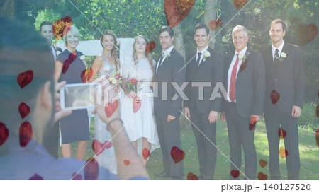 Wedding party photography is being shown in flat design garden, with smartphone and heart overlays Wedding party photography is being shown in flat design garden, with smartphone and heart overlays 140127520