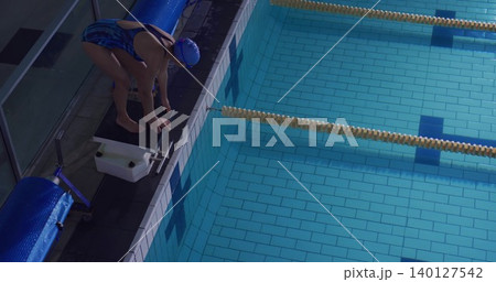 Swimmer is crouching on pool deck in flat design sports showing starting block, lane dividers Swimmer is crouching on pool deck in flat design sports showing starting block, lane dividers 140127542
