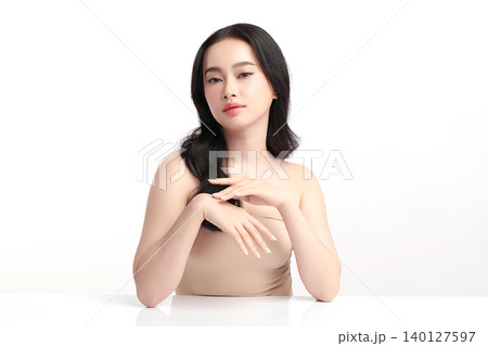 A beautiful young Asian woman with clean, fresh skin against a white background. Skincare, facial treatment, cosmetology, beauty, and spa. An elegant portrait of an Asian woman. A beautiful young Asian woman with clean, fresh skin against a white background. Skincare, facial treatment, cosmetology, beauty, and spa. An elegant portrait of an Asian woman. 140127597