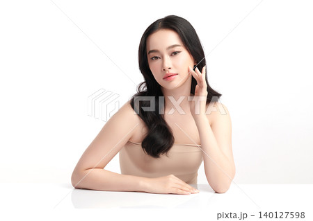 A beautiful young Asian woman with clean, fresh skin against a white background. Skincare, facial treatment, cosmetology, beauty, and spa. An elegant portrait of an Asian woman. A beautiful young Asian woman with clean, fresh skin against a white background. Skincare, facial treatment, cosmetology, beauty, and spa. An elegant portrait of an Asian woman. 140127598