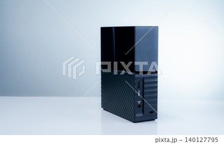Black solid state external hard drive on white background, perfect for digital data storage and fast backup solutions in modern offices, tech workspaces, and remote setups. Portable SSD device. Black solid state external hard drive on white background, perfect for digital data storage and fast backup solutions in modern offices, tech workspaces, and remote setups. Portable SSD device. 140127795