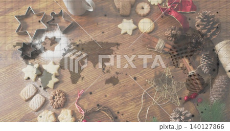 Showing holiday baking on wooden table with star cutters, cookies, powdered sugar, dotted overlay 140127866