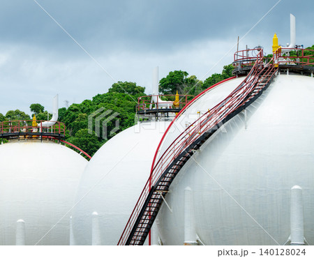 Industrial gas storage tank in factory, LNG or liquefied natural gas container in petroleum refinery. Energy industry infrastructure for natural gas storage. Global energy supply. Fuel reservoir. 140128024