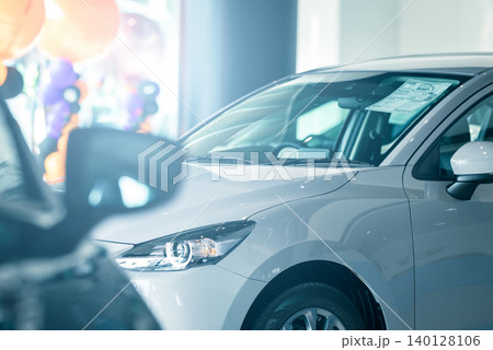 Elegant electric vehicle displayed in contemporary car dealership office, highlighting premium auto leasing, insurance options, and the future of urban transportation inside a modern indoor showroom. 140128106
