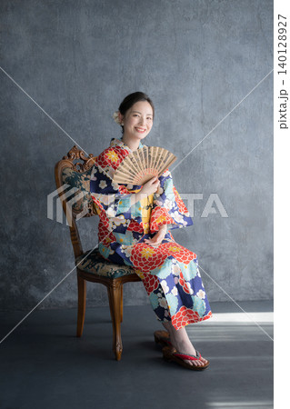 浴衣姿で扇子を持つ椅子に座る日本人女性の和風ビューティーポートレート 浴衣姿で扇子を持つ椅子に座る日本人女性の和風ビューティーポートレート 140128927