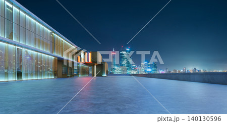 3d rendering modern building featuring illuminated glass facade with city skyline background 3d rendering modern building featuring illuminated glass facade with city skyline background 140130596