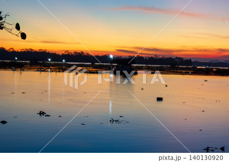 Beautiful Golden Sunset Over a Serene Lake with Water Reflections 140130920