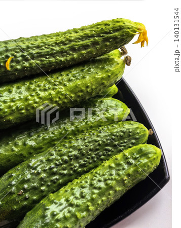 Fresh Cucumbers On Black Plate Close Up 140131544