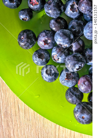 Fresh Blueberries On Green Plate Close Up Fresh Blueberries On Green Plate Close Up 140131557