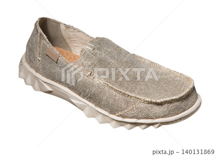 Men casual canvas slip-on shoe isolated on white background. Beige textile loafer moccasin with cork insole and textured sole, side view. Men casual canvas slip-on shoe isolated on white background. Beige textile loafer moccasin with cork insole and textured sole, side view. 140131869