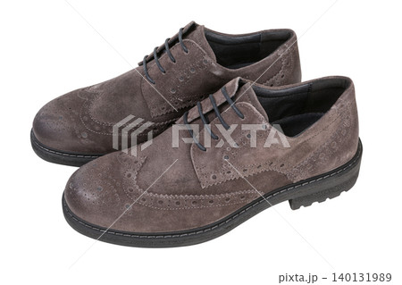 Pair of men taupe suede brogue shoes isolated on white background. Elegant brown wingtip oxford dress shoes with lace-up, high angle view. Pair of men taupe suede brogue shoes isolated on white background. Elegant brown wingtip oxford dress shoes with lace-up, high angle view. 140131989