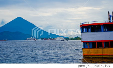 view of traditional boats on the pier with a mountain backdrop and clear sky view of traditional boats on the pier with a mountain backdrop and clear sky 140132195