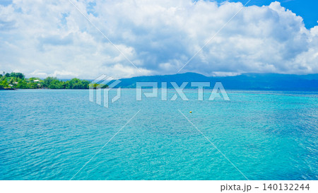 beautiful view of tropical beach with mountain backdrop and clear sky 140132244