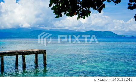 beautiful view of tropical beach with mountain backdrop and clear sky 140132245