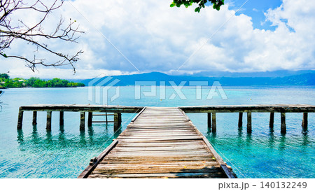 beautiful view of tropical beach with mountain backdrop and clear sky beautiful view of tropical beach with mountain backdrop and clear sky 140132249