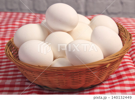 Basket of Farm Fresh Eggs on Red and White Checkered Fabric Basket of Farm Fresh Eggs on Red and White Checkered Fabric 140132449