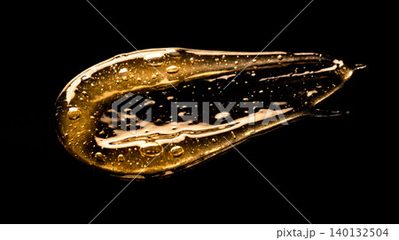 Golden cosmetic oil smear drop transparent gel serum texture with large bubbles black background abstract liquid skin care macro luxury beauty sample Golden cosmetic oil smear drop transparent gel serum texture with large bubbles black background abstract liquid skin care macro luxury beauty sample 140132504